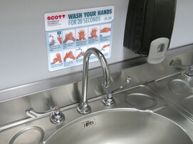 Covid-19 wash hands sign over sink Covid-19 wash hands sign over sink