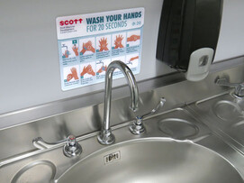 Tough wash hands sign over sink